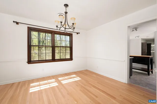 a view of a livingroom with wooden floor and a window