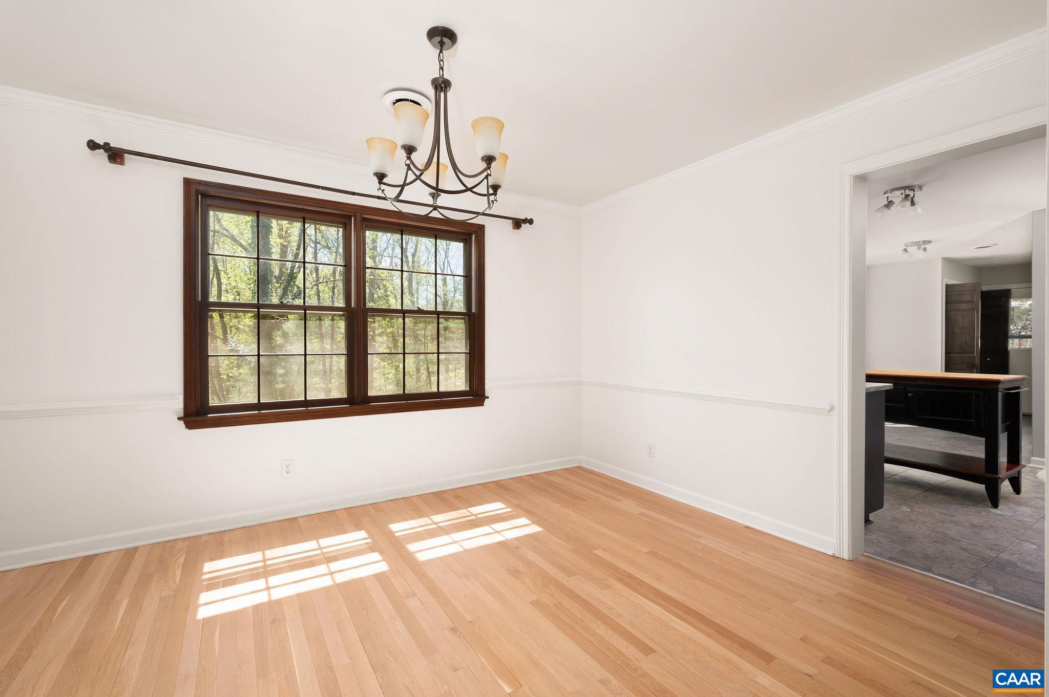 104 Smithfield Court, Unit A Charlottesville, VA 22901 - Photo 6 of 25 a view of a livingroom with wooden floor and a window