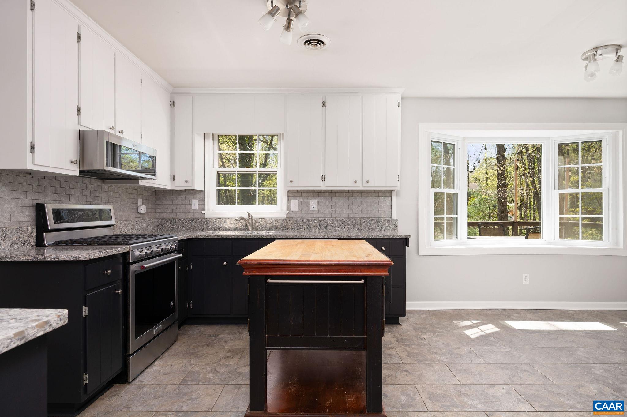 104 Smithfield Court, Unit A Charlottesville, VA 22901 - Photo 8 of 25 a kitchen with stainless steel appliances granite countertop a stove sink and cabinets