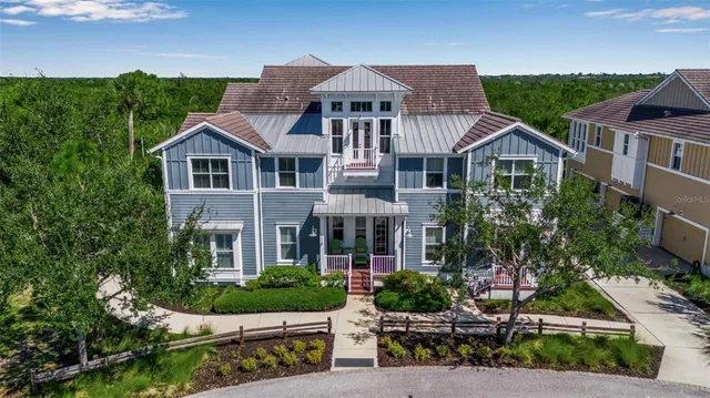 a front view of a house with porch garden and trees