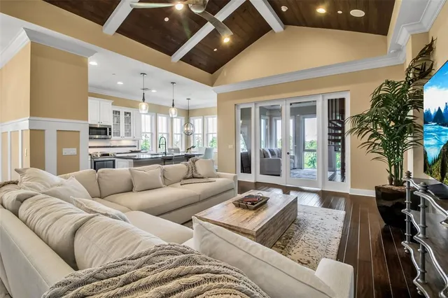 a dining room with furniture a wooden floor and a large window
