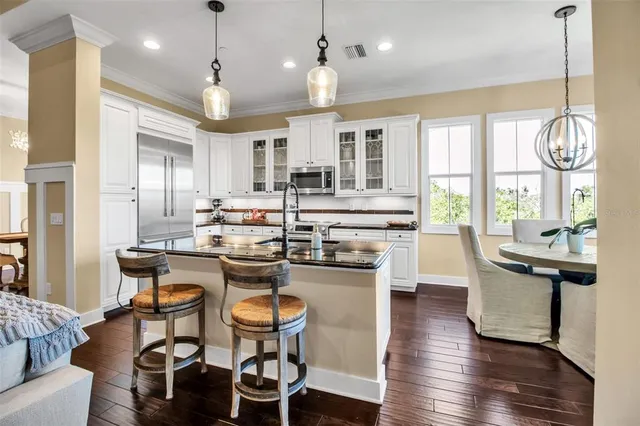 a bathroom with a double vanity sink a toilet a mirror and shower