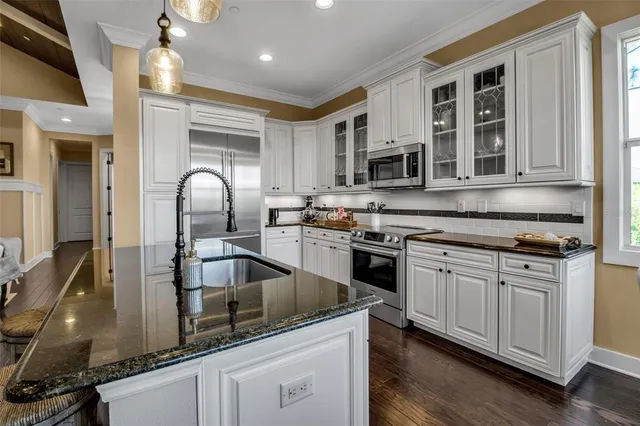 an aerial view of a house with outdoor space and a lake view
