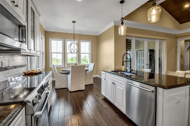 a view of a dining room with furniture and chandelier