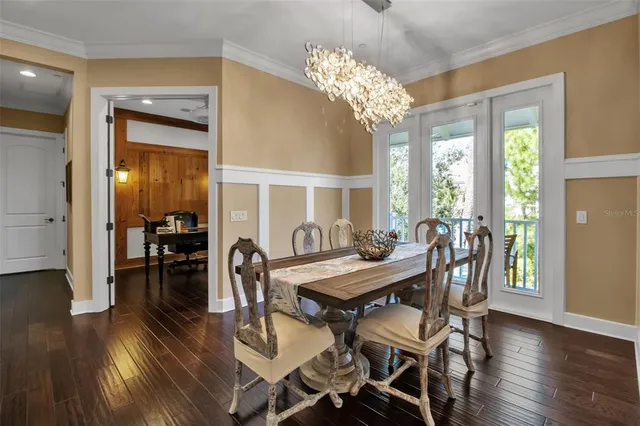 an aerial view of a house with a garden and lake view