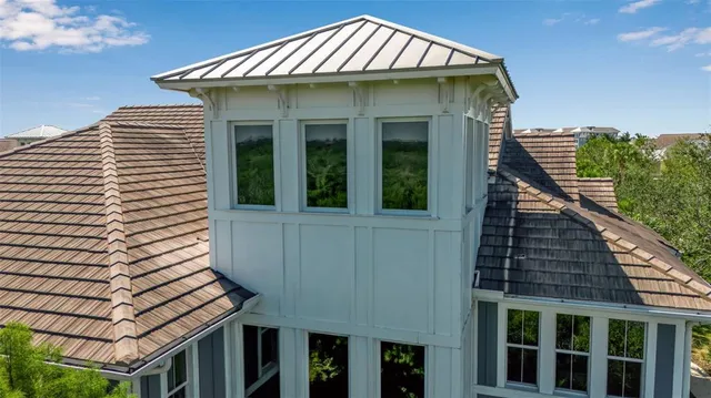 a front view of a house with yard and green space