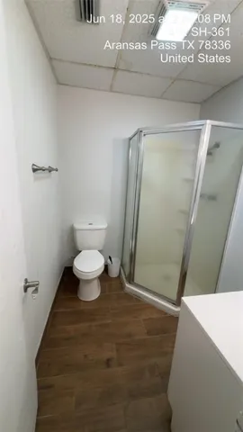 a bathroom with a toilet and a mirror