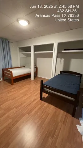 a room with wooden floor and furniture