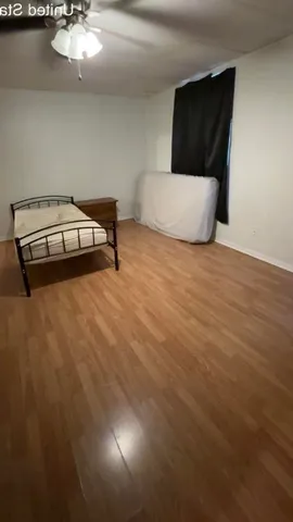 a living room with hard wood floors and a couch