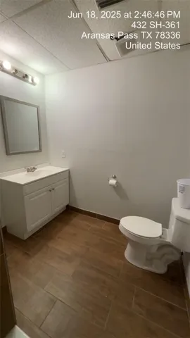 a bathroom with a toilet a sink and mirror