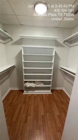 a view of a room with wooden floor and a window