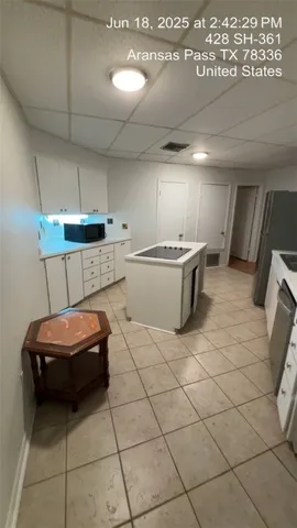 a kitchen with a sink and a stove top oven