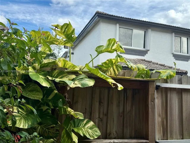 a vase of flowers with wooden fence