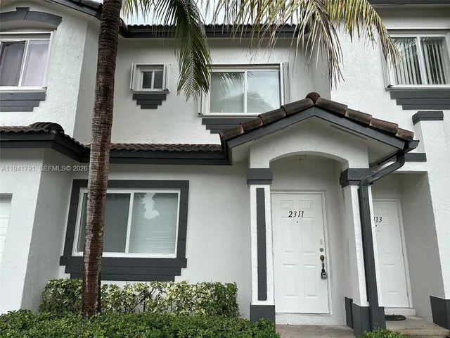 a front view of a house with garage