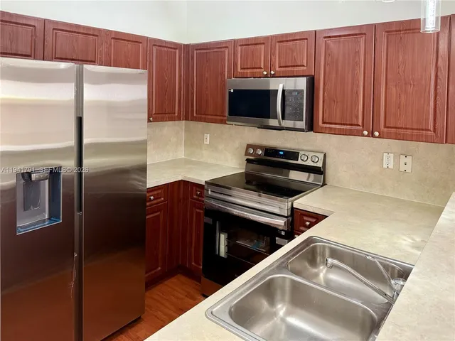 a kitchen with a refrigerator sink and microwave