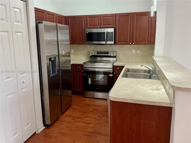 a kitchen with a refrigerator sink and microwave