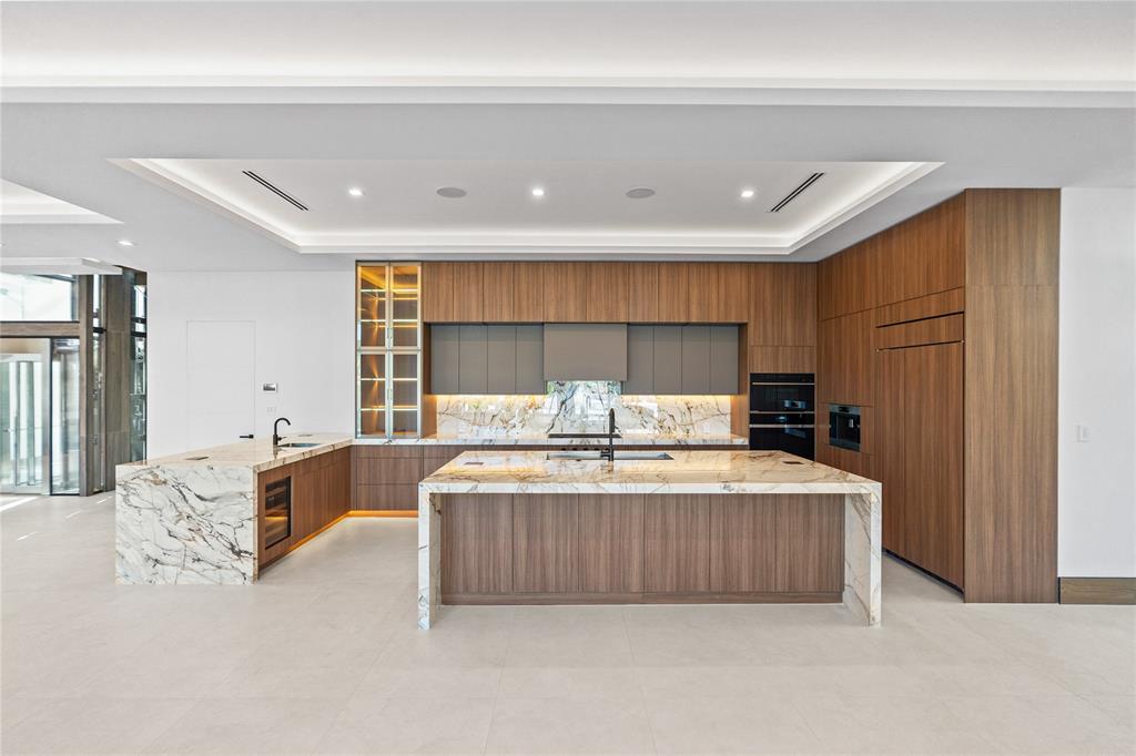 2441 Northeast 48th Court Lighthouse Point, FL 33064 - Photo 12 of 54 a large bedroom with a large bed and a dresser