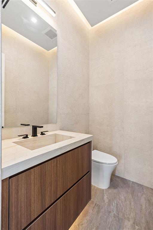 2441 Northeast 48th Court Lighthouse Point, FL 33064 - Photo 28 of 54 a bathroom with a sink and a toilet