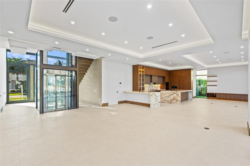 2441 Northeast 48th Court Lighthouse Point, FL 33064 - Photo 8 of 54 a view of a kitchen with furniture and a large window