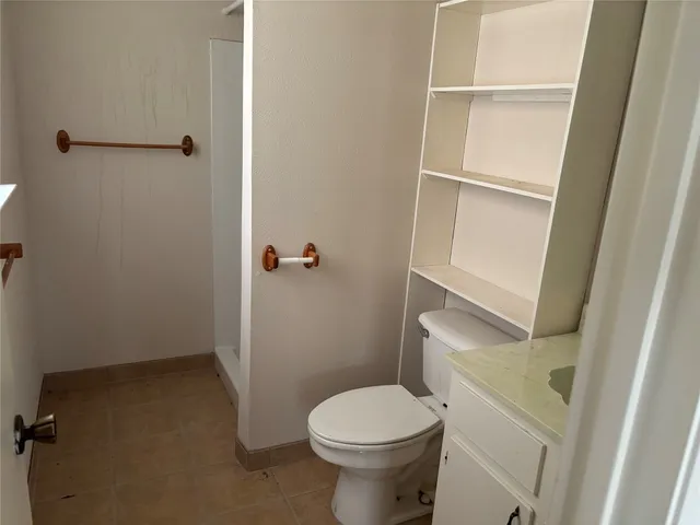 a white toilet sitting next to a sink