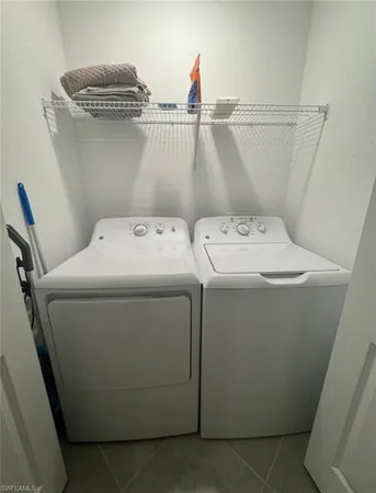a kitchen with a sink white cabinets and white appliances