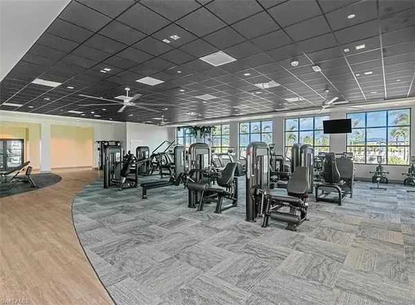 a view of a swimming pool with a lawn chairs under an umbrella
