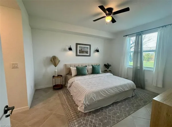 a bedroom with a bed and window