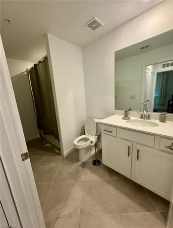 a bathroom with a sink toilet and mirror