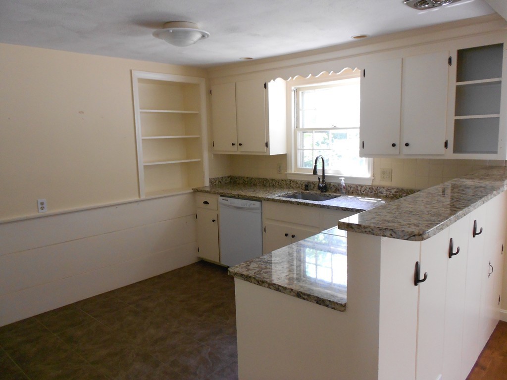 5 Singlefoot Road Chelmsford, MA 01824 - Photo 4 of 9 a kitchen with granite countertop a sink stove and cabinets