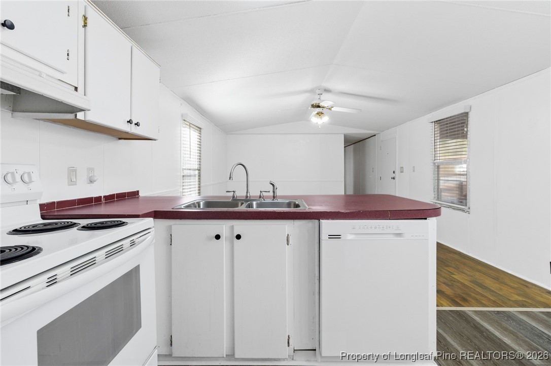 7321 Sheriff Watson Road Sanford, NC 27332 - Photo 10 of 26 a kitchen with stainless steel appliances granite countertop a sink and cabinets