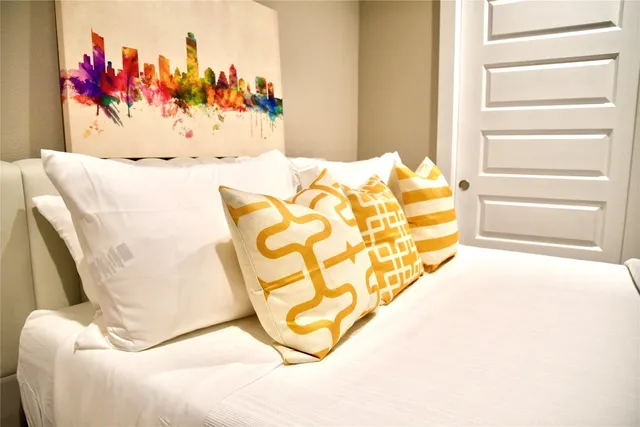 a bedroom with two beds and a flat screen tv