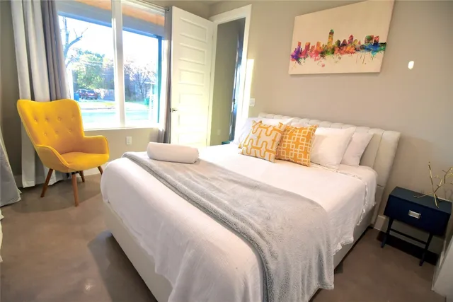 a bedroom with two beds and a large window