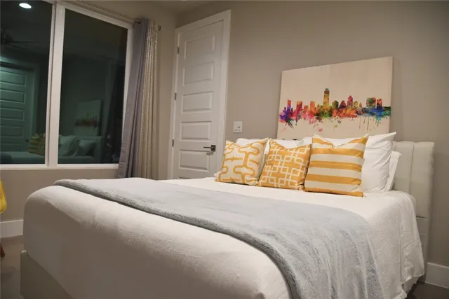 a bedroom with a bed and a flat screen tv