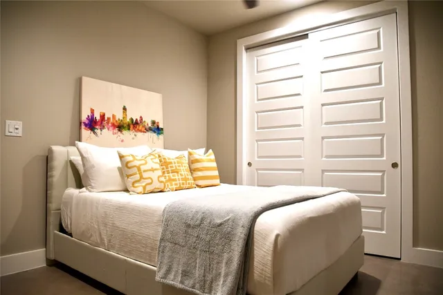 a open kitchen with stainless steel appliances kitchen island granite countertop a refrigerator a stove a sink a dining table and chairs with wooden floor