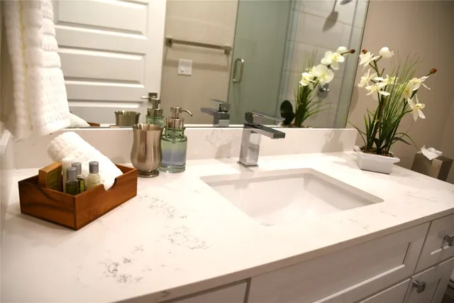 a large white bed in a bedroom next to a window