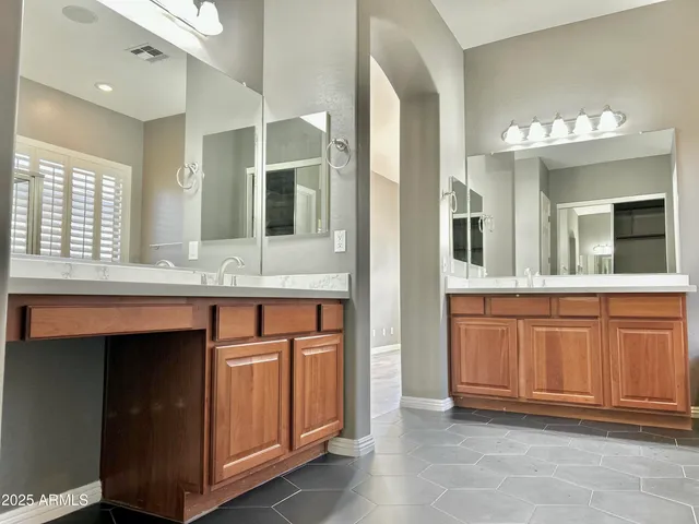 a bathroom with granite countertop a sink and mirror