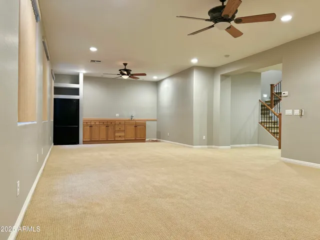 an empty room with a ceiling fan and entryway