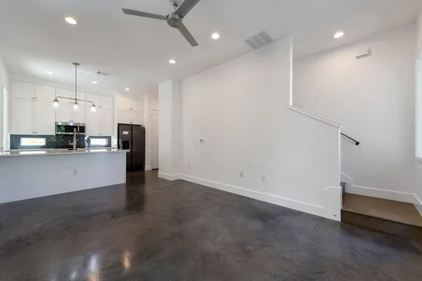 a view of kitchen with refrigerator and window