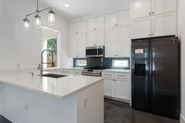 a kitchen with a refrigerator and a sink