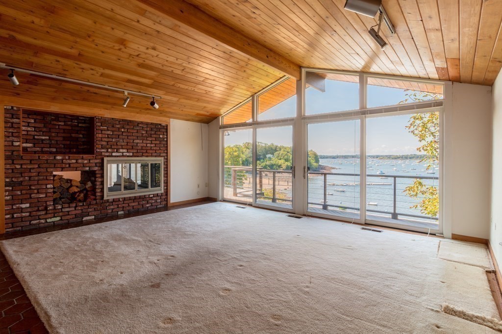 19 Kenneth Road Marblehead, MA 01945 - Photo 8 of 35 a view of an empty room with a fireplace and a window