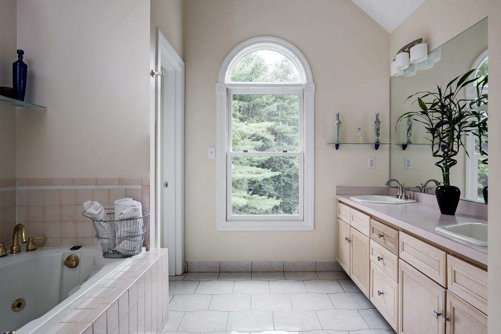 37 Edgewood Road Southborough, MA 01772 - Photo 21 of 29 a bathroom with a granite countertop sink a large mirror and a window
