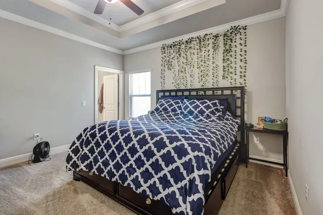 a bedroom with a bed and a chandelier