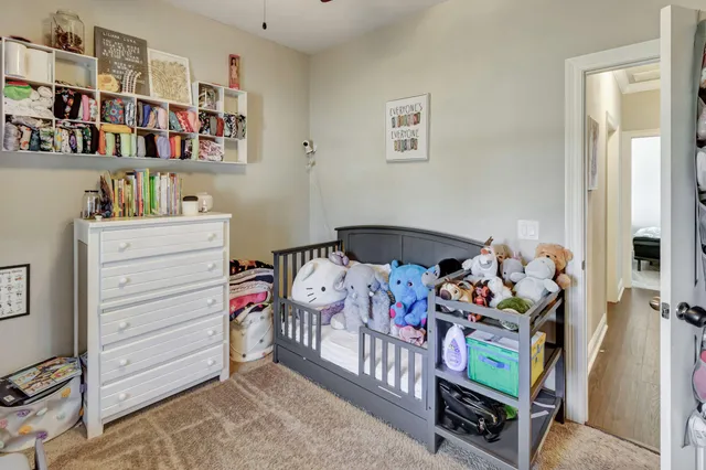 a bedroom with furniture and a baby crib