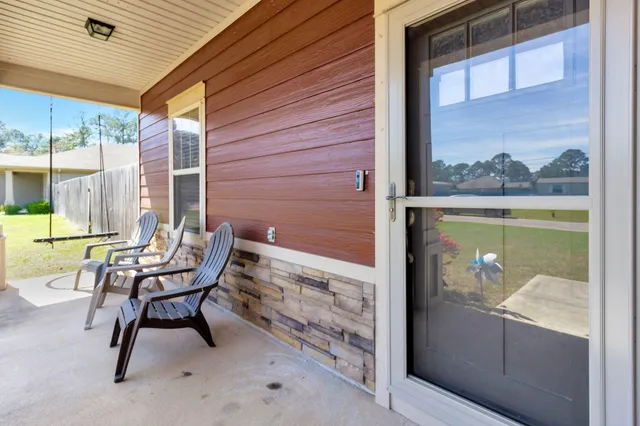 a view of a two chairs in the balcony