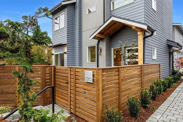 a front view of a house with plants