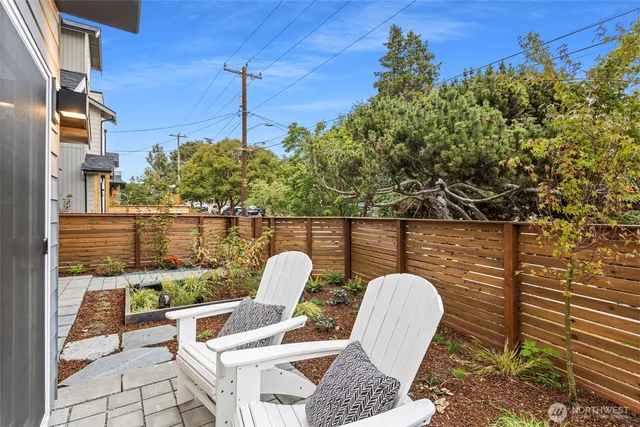 a kitchen with kitchen island a sink a stove a dining table and chairs