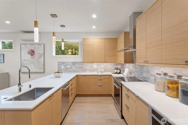 a kitchen with a sink and chairs