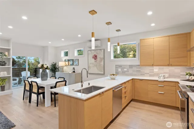 a kitchen with stainless steel appliances a refrigerator sink and stove