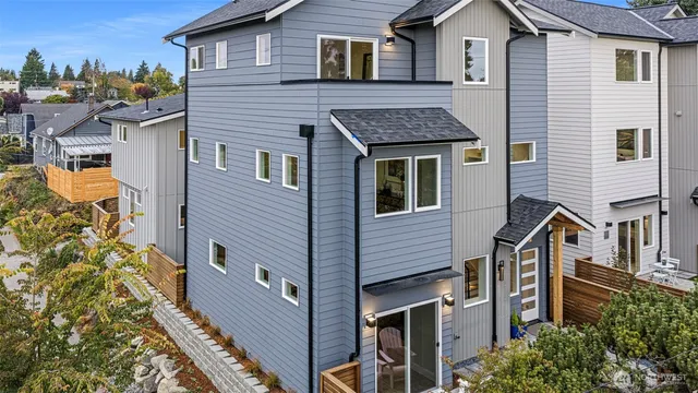 a aerial view of a house with a yard and balcony