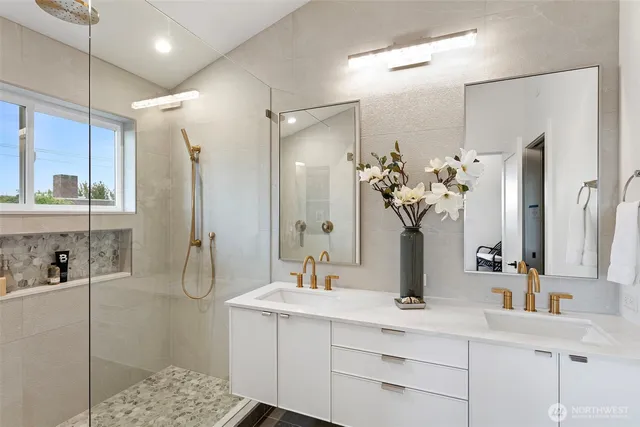 a bathroom with a sink a mirror and a shower